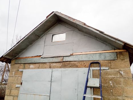 Repair of the pediment of the house. Steel pediment on the garage. Roof repair.