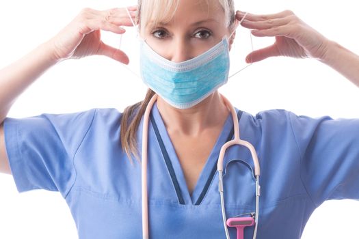 Close up of a nurse or doctor putting on a medical surgical ear loop face mask one of the critical PPE required.