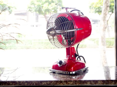 the red fan on a wooden table in cafe