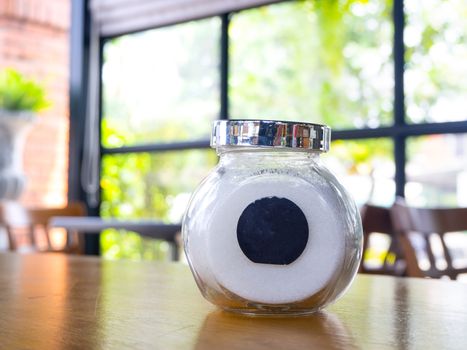 sugar in  glass jar on wood table for coffee.