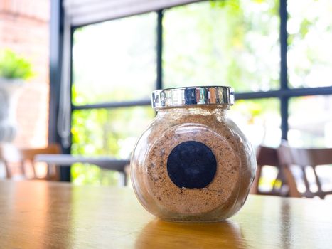 sugar in  glass jar on wood table for coffee.