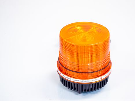 the Orange rotating beacon on white reflective background.