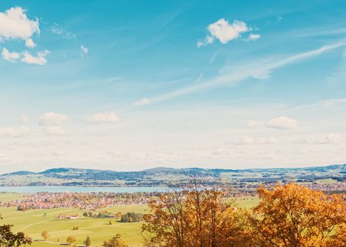 Beautiful nature of European Alps, landscape view of alpine mountains, lake and village in autumn season, travel and destination scenery