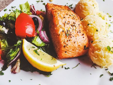 Grilled salmon, mashed potatoes and salad for lunch, served meal