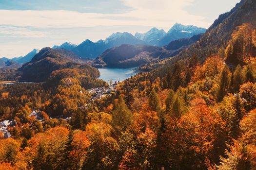 Beautiful nature of European Alps, landscape view of alpine mountains, lake and village in autumn season, travel and destination scenery