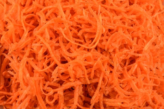 Healthy food background - grated carrot in close-up as a texture