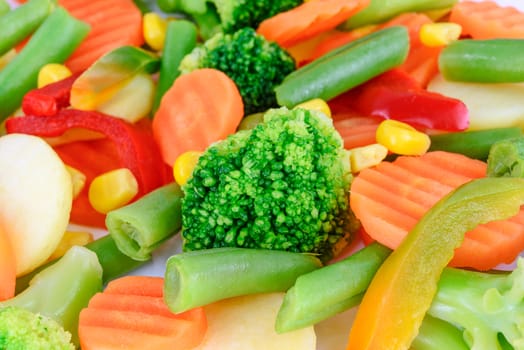 Mixed chopped fresh vegetables in close-up as a background