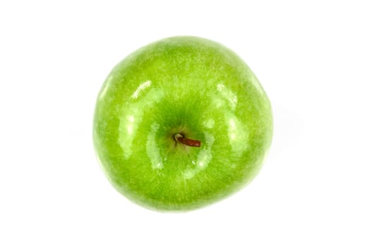 Top view of a shiny and fresh green apple in close-up and isolated on a white background.