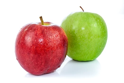 Two fresh apples in red and green color with drops of water and isolated on a white background.