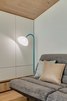 Fragment of a modern room with a sofa and floor lamp