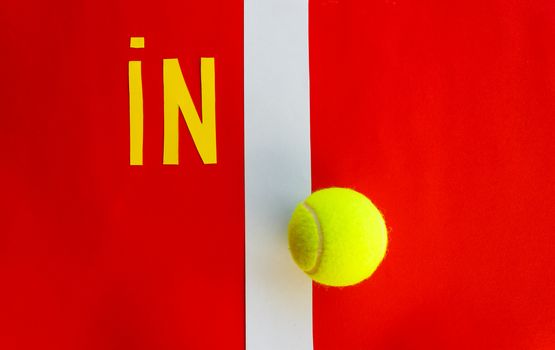 the writing in the tennis indicates that the ball has touched the line
