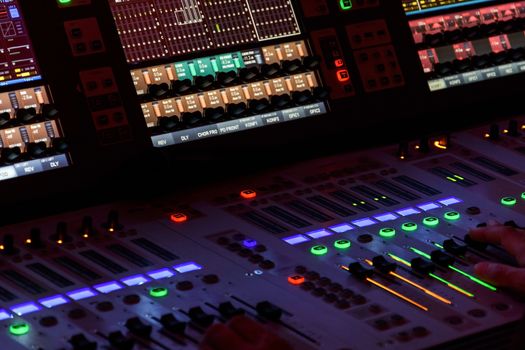 Director working on the video or sound mixing console in the studio