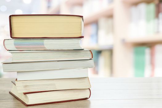 Concept image of education and learning - stocks of books on a desk in the library with copy space