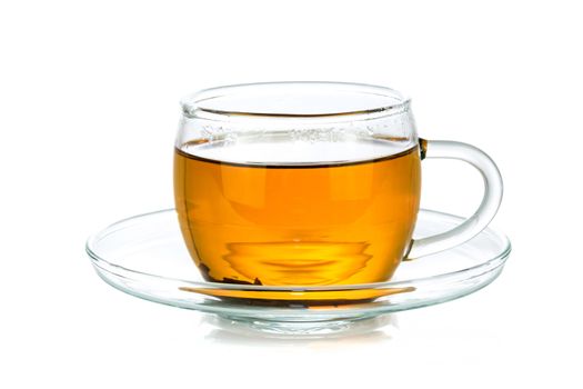 Transparent glass cup of tea isolated on a white background in close-up 