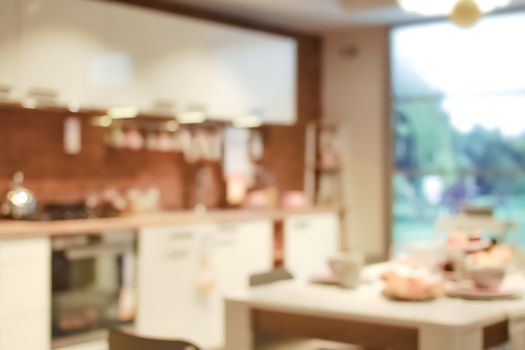 Beautifully blurred background interior of a modern kitchen overlooking the garden