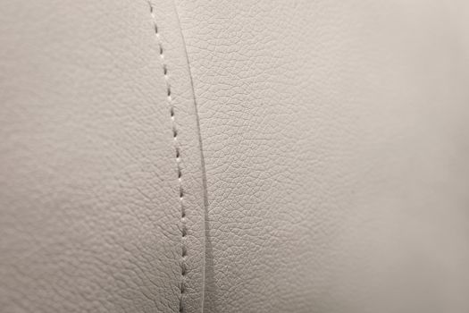 White leather texture with seams in close-up background