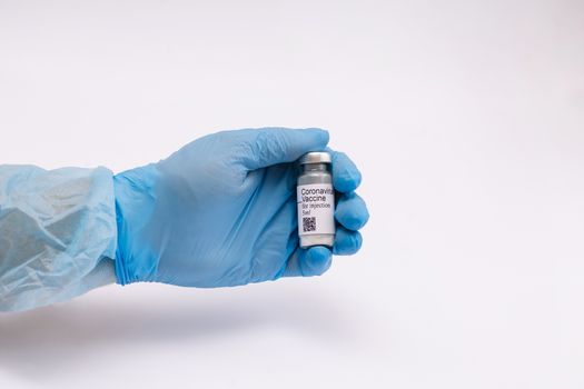 Coronavirus vaccine. Doctor with a vaccine. Hands holding a coronavirus vaccine ampoule, against Covid-19.