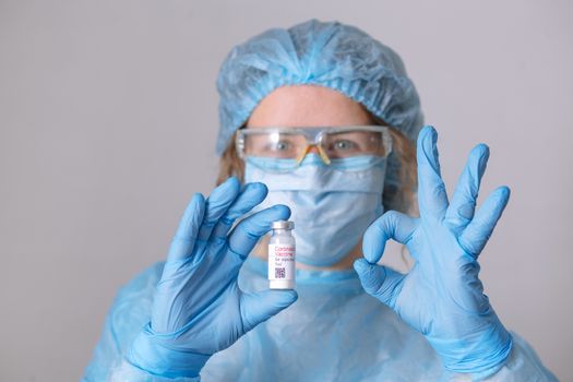 Coronavirus vaccine. Doctor with a vaccine. Nurse holding a coronavirus vaccine. Hands holding a coronavirus vaccine ampoule, against Covid-19.