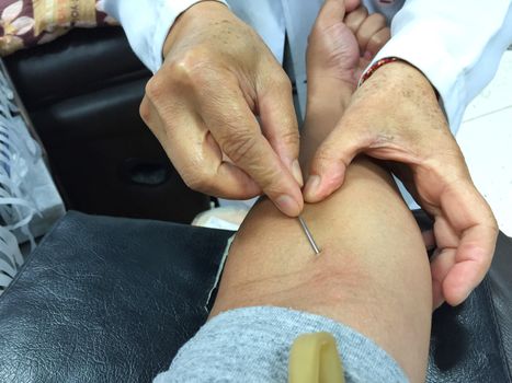 horizontal photo of closeup asian male get injection on his arm before blood donation