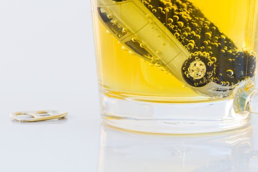 horizontal photo of toy car in a glass of beer isolated on white background. Drunk-driving Prevention Concept.