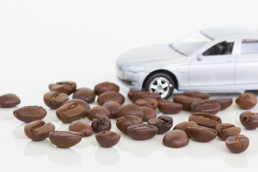 horizontal photo of coffee beans with a car on the background.