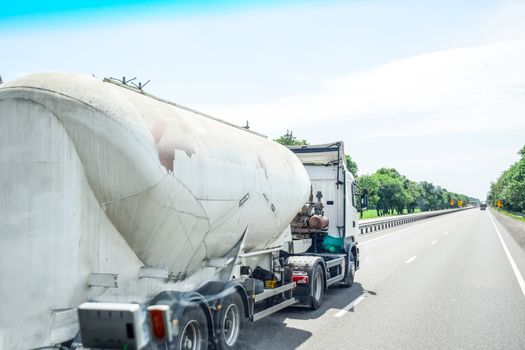 Cement locomotive rides on the track, white cement truck carries cement