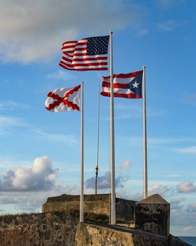 The three flags that fly at El Morro in Old San Juan, Puerto Rico. American, Puerto Rican and Cross of Burgundy flags.