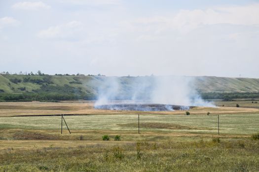 Fire in the field where hay was grown. burning dry grass