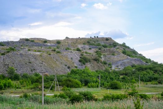 ore slag dumps after processing. Old stepped terricon in the form of a hill with terraces