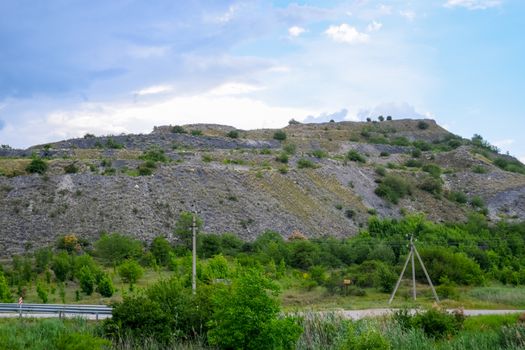 ore slag dumps after processing. Old stepped terricon in the form of a hill with terraces