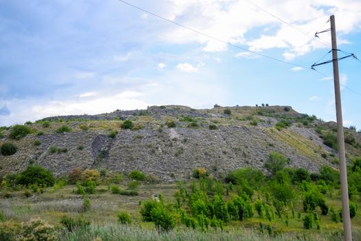 ore slag dumps after processing. Old stepped terricon in the form of a hill with terraces