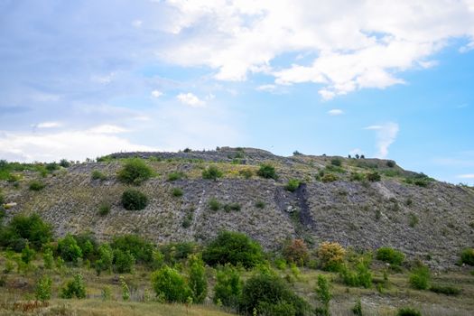 ore slag dumps after processing. Old stepped terricon in the form of a hill with terraces