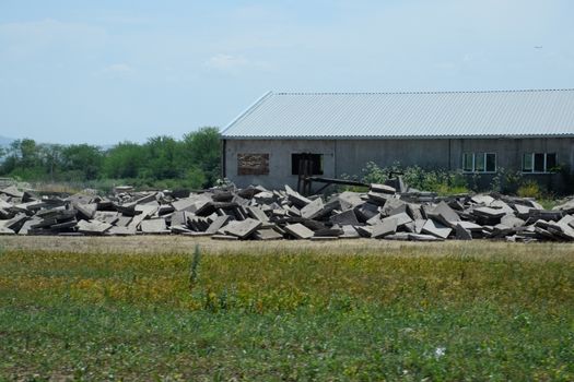 pile of concrete slabs piled up near the old building.