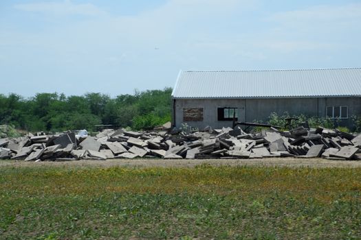 pile of concrete slabs piled up near the old building.