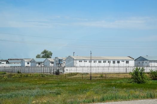 The building and the fence of the prison. Prison Correctional Facility.