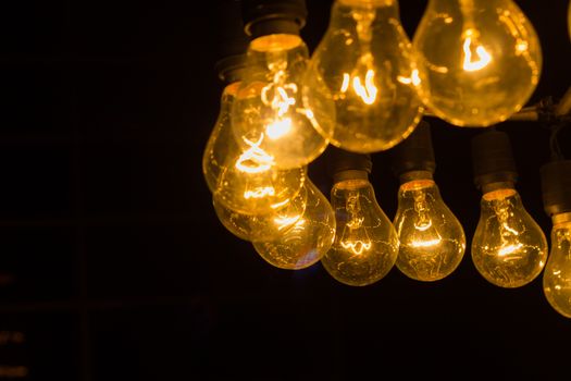 old curved retro light bulbs  in the night, copyspace on the left