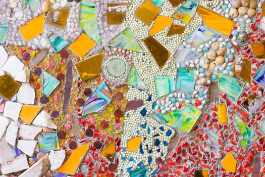 Colorful mosaic abstract background made of broken glass and ceramic pots.