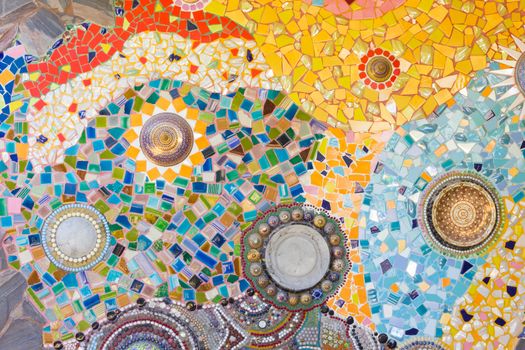 Colorful mosaic abstract background made of broken glass and ceramic pots.