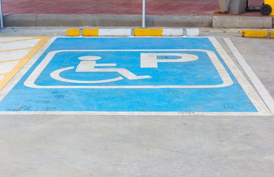 Disabled parking sign in filling station, Thailand.