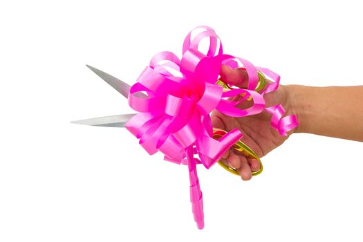 mans hand cutting something with scissors and pink bow isolated on white background.