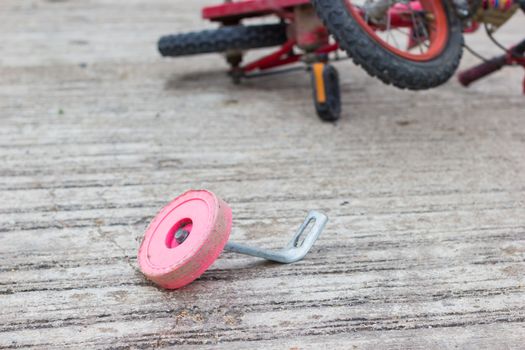 horizontal photo of closeup bicycle for children accident on the city street.