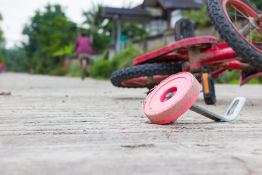 horizontal photo of closeup bicycle for children accident on the city street.