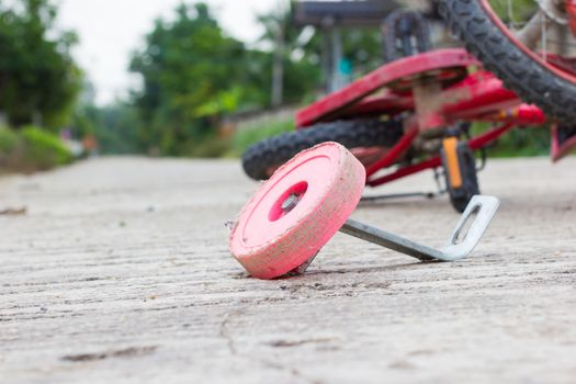 horizontal photo of closeup bicycle for children accident on the city street.