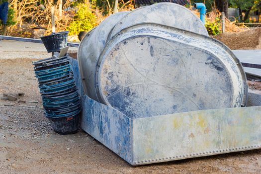 salvers and buckets after using in construction site, horizontal photo