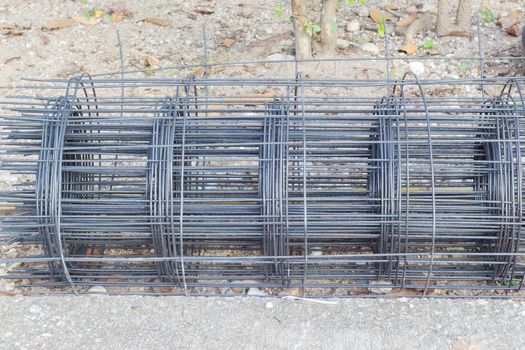 Rolls of steel wire mesh on the ground, horizontal photo.