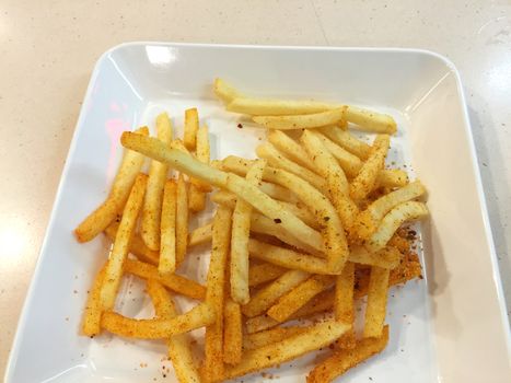 spicy french fries on white dish in restaurant, Thailand