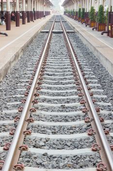 perspective train tracks at the railway station