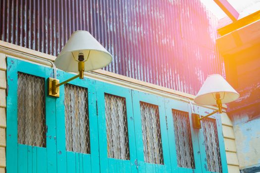 perspective vintage green wooden wall with white retro lamps