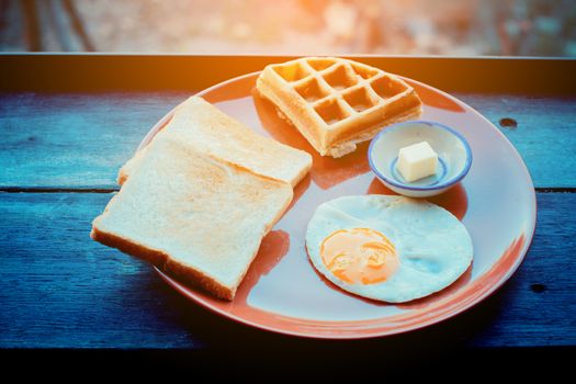 breakfast set of hotel in Thailand on wooden table. Retro filter.