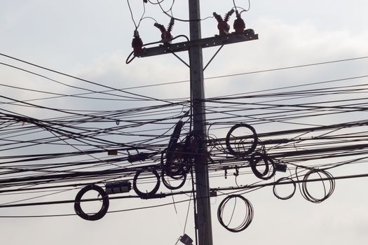 Messy electrical cables and wires on electric pole in Bangkok, Thailand